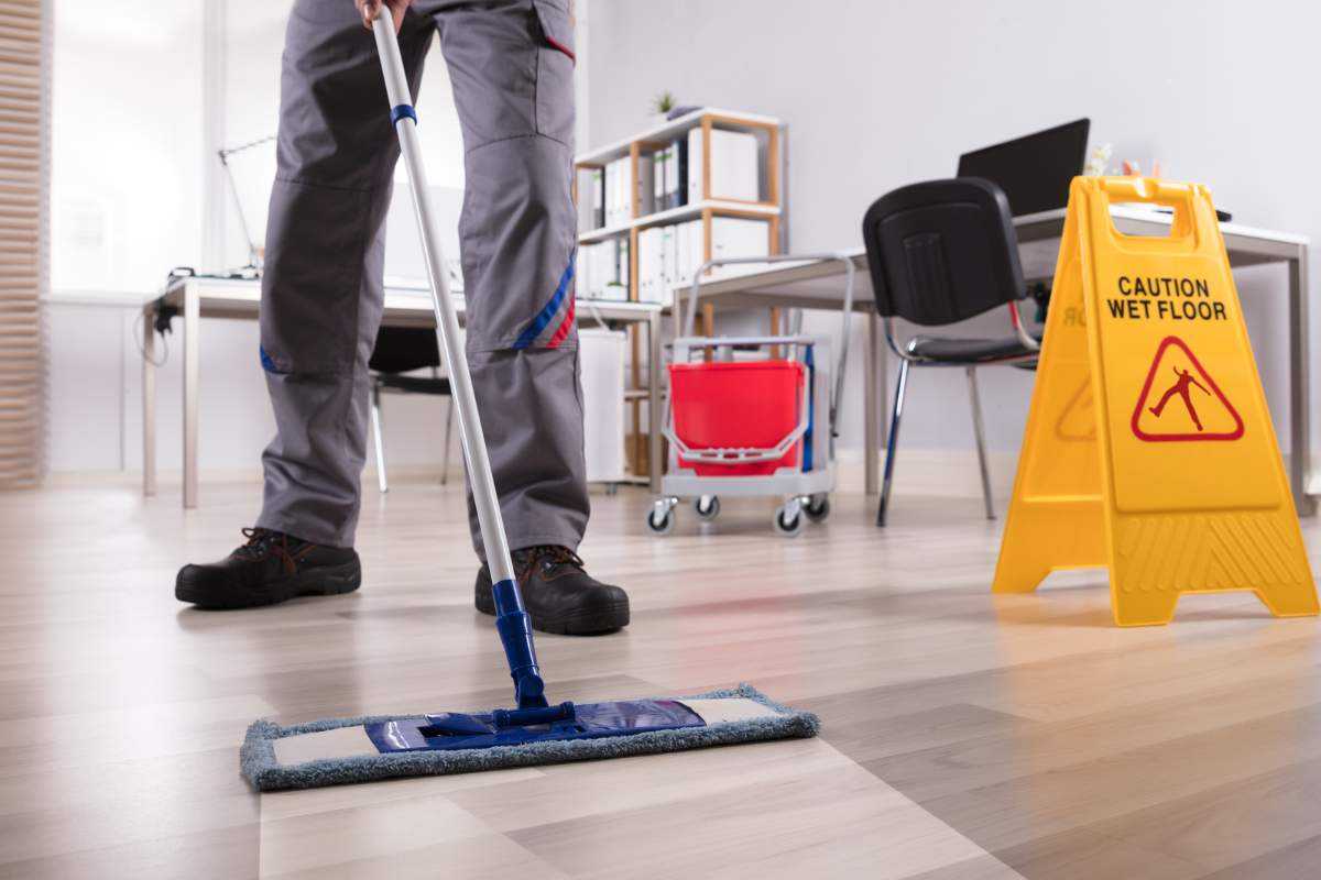 Man Cleaning Commercial hardwood Flooring